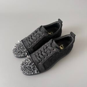 AuroraCustom Christian Louboutin Louis Junior Spikes studded J low-top sneakers in black glitter.